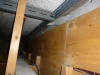 asbestos-board-to-bulkhead-above-shop-front-and-behind-wood-overboard